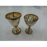 Two white metal egg cups, one with beaded edge design, possibly foreign