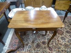 An antique French fruitwood side table, having a long drawer on carved cabriole legs, 78.5 cms