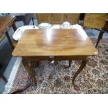 An antique French fruitwood side table, having a long drawer on carved cabriole legs, 78.5 cms