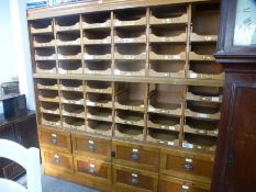 A vintage oak Haberdasher's shop unit having 45 sliding trays with eight drawers below - 3 trays mis