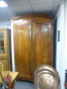 A large French cherrywood armoire having two doors