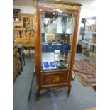 A French style pillar display cabinet, having gilt metal mounts with inlaid panel