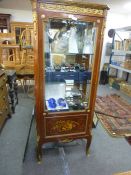 A French style pillar display cabinet, having gilt metal mounts with inlaid panel