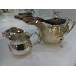 Two silver jugs, one being hallmarked London 1933, Pearce & Sons Ltd, Silversmiths, dented, together