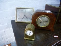 An Art Deco brass easel clock having silvered dial and two other clocks