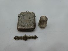 A small silver lot comprising of a Victorian ornate match holder of foliate design with central cart