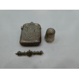A small silver lot comprising of a Victorian ornate match holder of foliate design with central cart