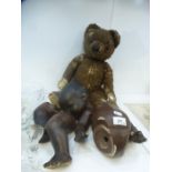 An Armand Marseille 351/8K black bisque head doll and an old teddy bear