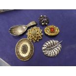 Small collection of brooches and silver scalloped spoon