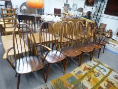 A set of six Ercol stickback kitchen chairs including a pair with open arms