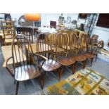 A set of six Ercol stickback kitchen chairs including a pair with open arms