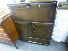 An Ercol dark oak sideboard having cupboards and drawers, and a similar smaller example