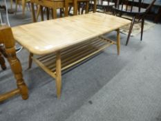 An Ercol light oak oblong coffee table having shelf under 104.5cms