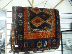 A large Kurdish saddle bag, having blue border of stylised flowers, 165 x 113cms