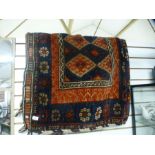 A large Kurdish saddle bag, having blue border of stylised flowers, 165 x 113cms