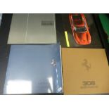 Four Ferrari car brochures