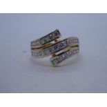 18ct two tone gold crossover ring, set with 23 diamonds, size P, weight approx 4.6g, marked 750