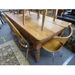 An antique pine kitchen table having two drawers on turned legs, 219 cms