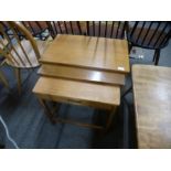 A nest of teak coffee tables, the smallest having long drawer, probably 1970s