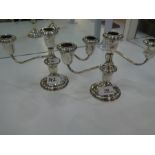 A pair of silver candelabras marked 'Lord Silver inc silver weighted'