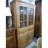 An antique pine dresser having pair of glazed doors, 114 cms