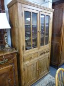 An antique pine dresser having pair of glazed doors, 114 cms