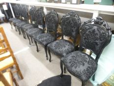 A set of eight black painted dining chairs having pierced splats