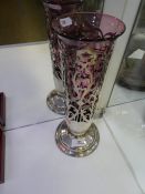 A heavy silver pierced case cover with cranberry glass vase insert.  Of pierced decorative design, h