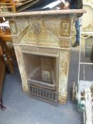 A Victorian cast iron fireplace, with grate