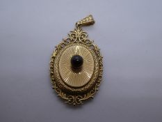9ct yellow gold oval locket, with central red stone, marked 375, 4cm, weight approx 5.8g