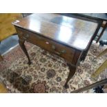 An antique oak side table having one long drawer on cabriole legs, 77 cms
