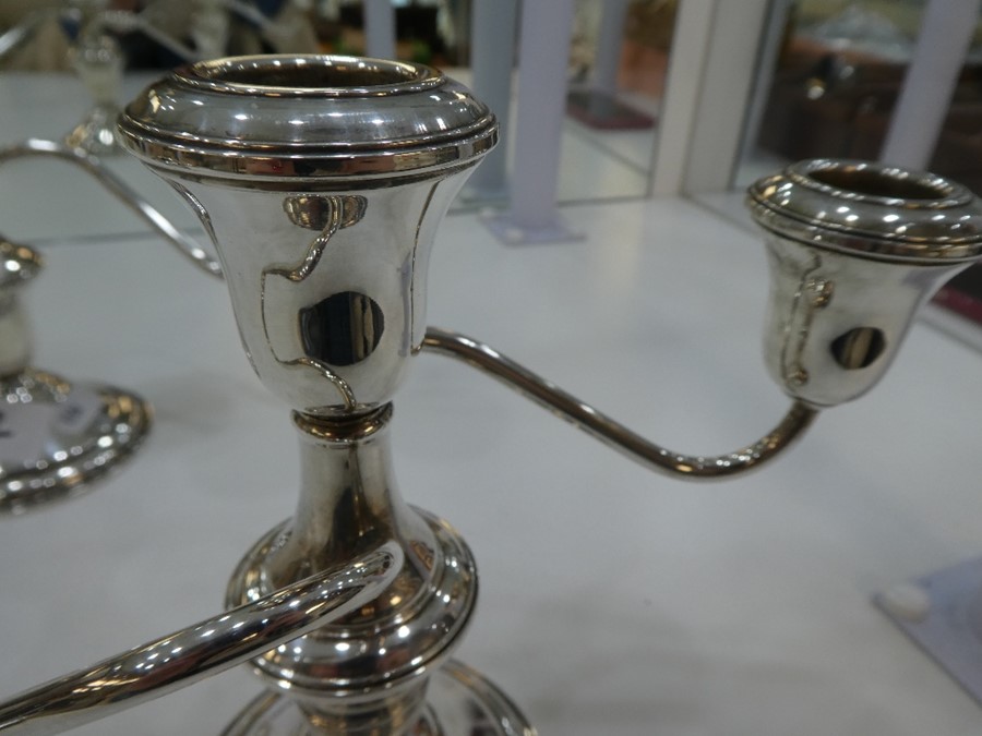A pair of silver candelabras marked 'Lord Silver inc silver weighted' - Image 2 of 4