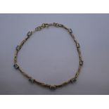 Pretty 9ct yellow gold bracelet set with 9 pale blue stones, marked 375