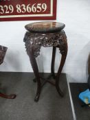A Chinese carved hardwood jardiniere stand with pierced decoration and rouge marble top, 92 cms high