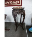 A Chinese carved hardwood jardiniere stand with pierced decoration and rouge marble top, 92 cms high