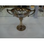 A Silver bowl of shallow proportion on an ornate circular base and decorative handles hallmarked Bir