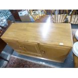 An Ercol Elm sideboard having cupboard and one drawer, 114 cms