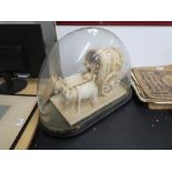 An antique glass dome and base, the interior having model of Ox and cart, 52 cms