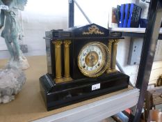 A Victorian black painted metal mantel clock having gilt decoration