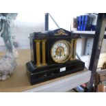 A Victorian black painted metal mantel clock having gilt decoration