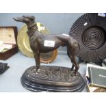 A reproduction bronzed sculpture of greyhound an oval base