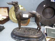 A reproduction bronzed sculpture of greyhound an oval base