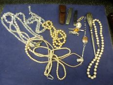 Small box of costume jewellery to include brooches, necklaces, silver handled button hook