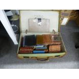 An old canvas suitcase, a Mah Jong set, books and sundry