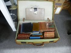 An old canvas suitcase, a Mah Jong set, books and sundry