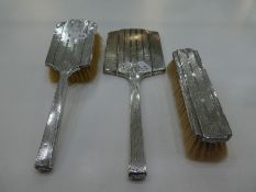 Silver backed three piece dressing table set comprising of two brushes and hand held mirror, Birming