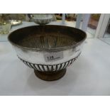 A silver Edwardian small punch bowl, with half reeded body on a raised spreading pedestal foot, also