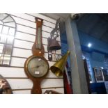An antique banjo barometer having inlaid decoration