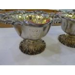 A decorative pair of Victorian ornate silver bon bon bowls with silver gilt interior ad foliate deco