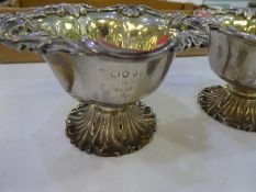 A decorative pair of Victorian ornate silver bon bon bowls with silver gilt interior ad foliate deco